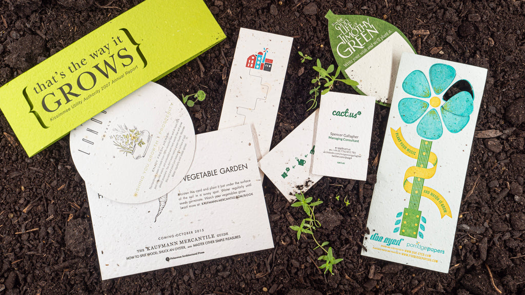 Coasters, bookmarks and custom plantable products on top of sprouting soil